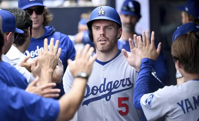 Los Angeles Dodgers' Freddie Freeman (5) celebrates after scoring on a single by Andy Pages during the sixth inning of a baseball game against the Tampa Bay Rays, Sunday, Aug. 3, 2025, in Tampa, Fla. (AP Photo/Jason Behnken)
