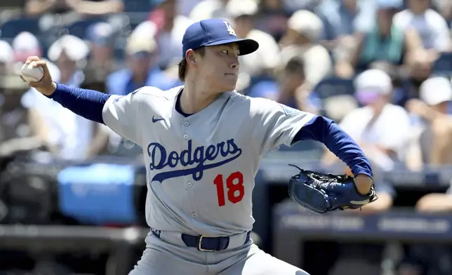 Los Angeles Dodgers pitcher Yoshinobu Yamamoto throws during the sixth inning of a baseball game against the Tampa Bay Rays, Sunday, Aug. 3, 2025, in Tampa, Fla. (AP Photo/Jason Behnken)