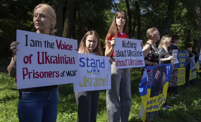 People attend a rally ahead to the meeting between U.S. President Donald Trump and Russian President Vladimir Putin, during a rally in front of the U.S. Embassy in Kyiv, Ukraine, Friday, Aug. 15, 2025. (AP Photo/Efrem Lukatsky)