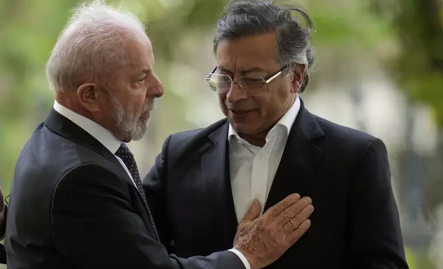 Brazil's President Luiz Inacio Lula da Silva pats Colombia's President Gustavo Petro during a meeting of leaders of the Amazon Cooperation Treaty Organization in Bogota, Colombia, Friday, Aug. 22, 2025. (AP Photo/Fernando Vergara)
