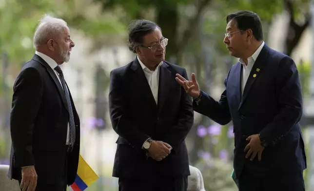 Bolivia's President Luis Arce, right, talks to Brazil's President Luiz Inacio Lula da Silva, left, and Colombia's President Gustavo Petro during a meeting of leaders of the Amazon Cooperation Treaty Organization in Bogota, Colombia, Friday, Aug. 22, 2025. (AP Photo/Fernando Vergara)