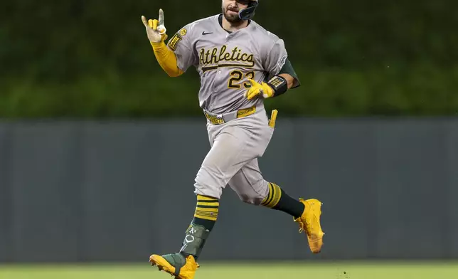 Athletics catcher Shea Langeliers (23) celebrates as he rounds the bases after hitting a two-run home run in the 10th inning of a baseball game in Minneapolis, Minn., on Wednesday, Aug. 20, 2025. (Carlos Gonzalez/Star Tribune via AP)