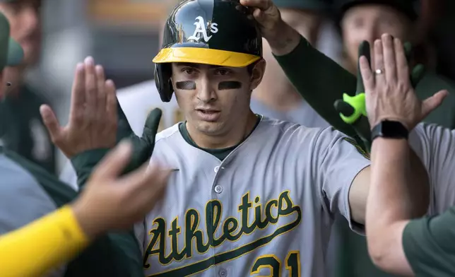 Athletics' Tyler Soderstrom (21) celebrates with teammates after hitting a home run against the Minnesota Twins in the fourth inning of a baseball game, in Minneapolis, Wednesday, Aug. 20, 2025. (Carlos Gonzalez/Star Tribune via AP)