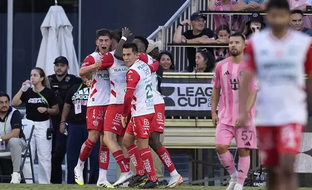 Necaxa forward Tomas Badaloni, left, celebrates with teammates after scoring his side's first goal during the first half of a Leagues Cup soccer match against Inter Miami, Saturday, Aug. 2, 2025, in Fort Lauderdale, Fla. (AP Photo/Rebecca Blackwell)