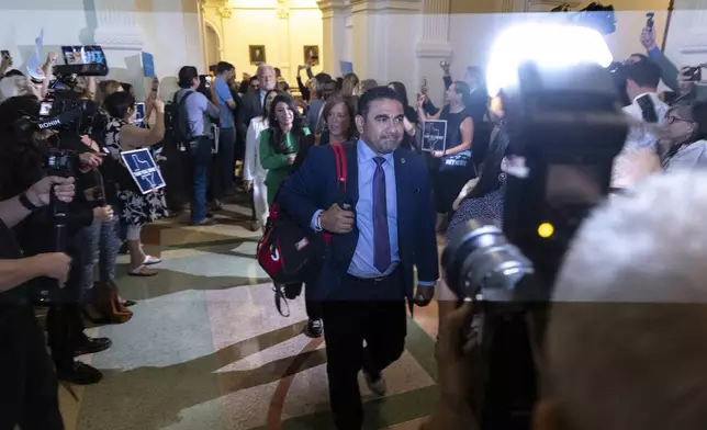 Texas State Rep. Armando Walle enters the house chambers at the Texas Capitol in Austin, Texas, Tuesday, Aug. 18, 2025. (AP Photo/Stephen Spillman)