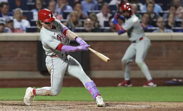 Philadelphia Phillies' Harrison Bader hits a two-run home run leading Nick Castellanos to score during the eighth inning of a baseball game against the New York Mets, Tuesday, Aug. 26, 2025, in New York. (AP Photo/Pamela Smith)