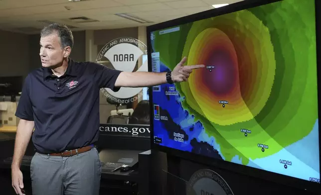 Jamie Rhome, deputy director of the National Hurricane Center, gives an update on Tropical Storm Erin at the National Hurricane Center, Thursday, Aug. 14, 2025, in Miami. (AP Photo/Lynne Sladky)