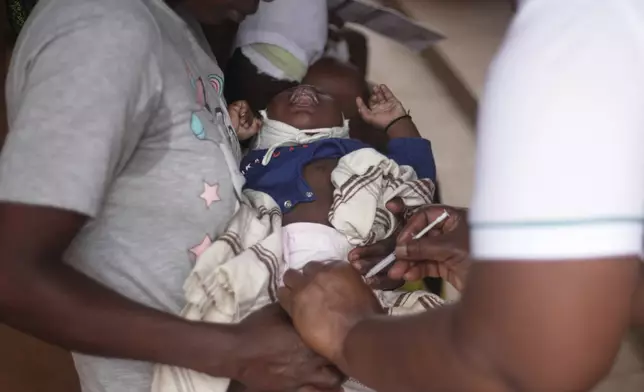 A child receives a vaccine shot at Wakiso Health Centre IV in Wakiso, Uganda, Wednesday, July 23, 2025. (AP Photo/Patrick Onen)