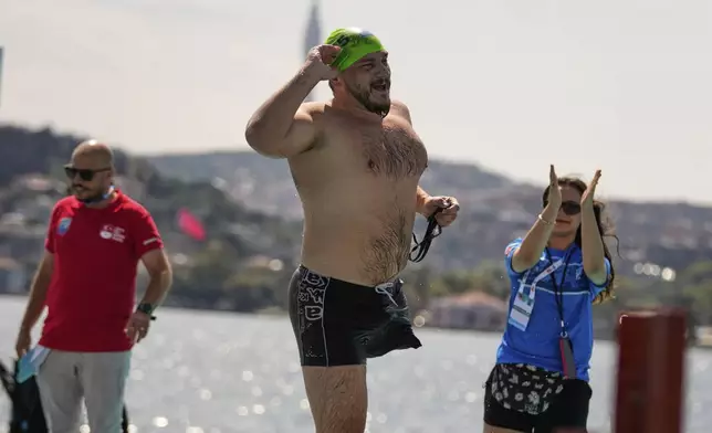 Ukrainian war veteran Oleksandr Dashko crosses the finish line during a 6.5km swimming race across the Bosporus Strait, from the Asian side to the European side, in Istanbul, Turkey, Sunday, Aug. 24, 2025. (AP Photo/Khalil Hamra)