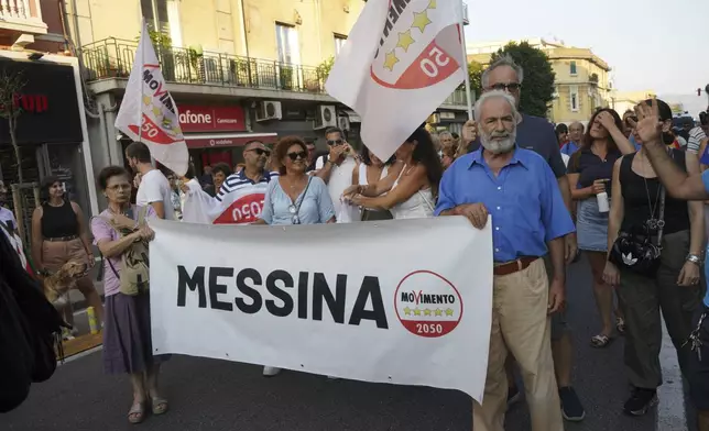 People hold a banner during a demonstration against the bridge in Messina, Italy on Saturday, Aug. 9, 2025 (Francesco Saya/LaPresse via AP)