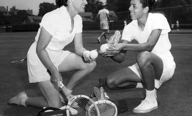 FILE - Sarah Palfrey Cook, left, chats with Althea Gibson, National Negro Women's Tennis Champion from Sumter, S.C., at the west side tennis club at Forest Hills, New York on July 29,1950. (AP Photo,File)