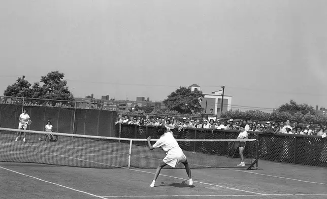 FILE - Althea Gibson, forecourt, of New York City, makes a point return to Barbara Knapp of England during the National Tennis Championship in Forest Hills, New York, Aug. 28, 1950. (AP Photo/Harry Harris,File)