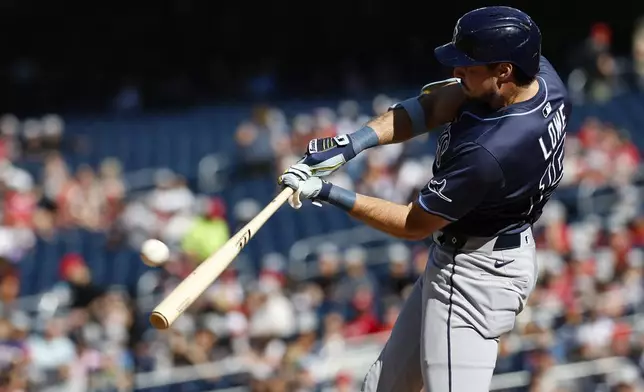 Tampa Bay Rays' Josh Lowe hits a three-run home run against Washington Nationals pitcher Jake Irvin, which scored Brandon Lowe and Junior Caminero, during the first inning of a baseball game, Saturday, Aug. 30, 2025, in Washington. (AP Photo/Terrance Williams)