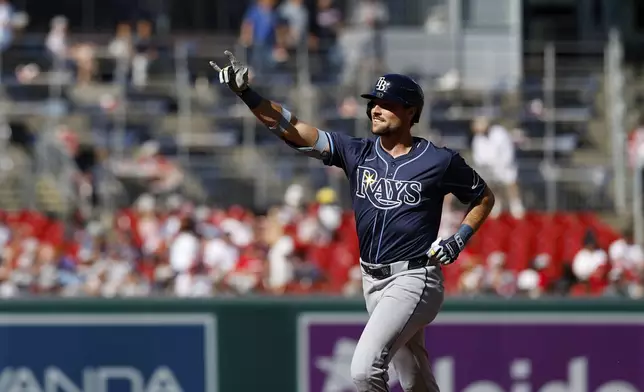 Tampa Bay Rays' Josh Lowe gestures as he runs the bases after hitting a three-run home run against Washington Nationals pitcher Jake Irvin, which scored Brandon Lowe and Junior Caminero, during the first inning of a baseball game, Saturday, Aug. 30, 2025, in Washington. (AP Photo/Terrance Williams)