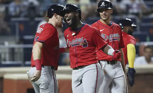 Atlanta Braves' Michael Harris II, center, celebrates his grand slam during the fourth inning of a baseball game against the New York Mets, Wednesday, Aug. 13, 2025, in New York. (AP Photo/Heather Khalifa)