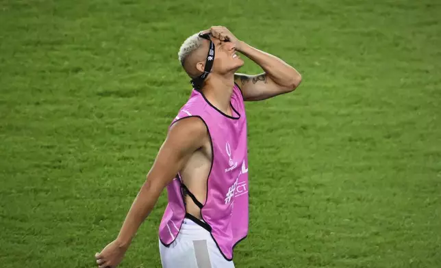 Tottenham's Richarlison grimaces as he walks away with his losers medal after the UEFA Super Cup soccer match between Paris Saint-Germain and Tottenham Hotspur in Udine, Italy, Thursday, Aug. 14, 2025. (AP Photo/Denes Erdos)
