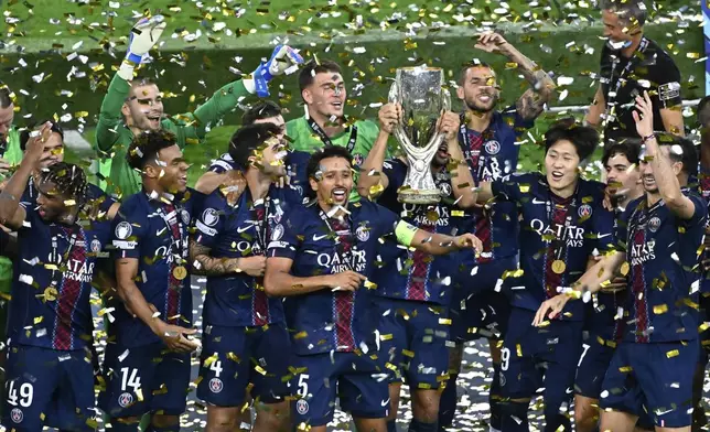 PSG's players celebrate with the trophy after the UEFA Super Cup soccer match between Paris Saint-Germain and Tottenham Hotspur in Udine, Italy, Thursday, Aug. 14, 2025. (AP Photo/Denes Erdos)