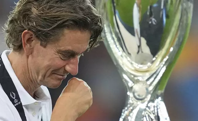 Tottenham's coach Thomas Frank walks past the trophy during the medal ceremony after the UEFA Super Cup soccer match between Paris Saint-Germain and Tottenham Hotspur in Udine, Italy, Wednesday, Aug. 13, 2025. (AP Photo/Antonio Calanni)