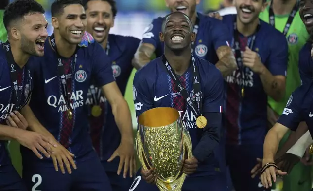 PSG's Ousmane Dembele celebrates with the trophy after winning the UEFA Super Cup soccer match between Paris Saint-Germain and Tottenham Hotspur in Udine, Italy, Wednesday, Aug. 13, 2025. (AP Photo/Darko Bandic)