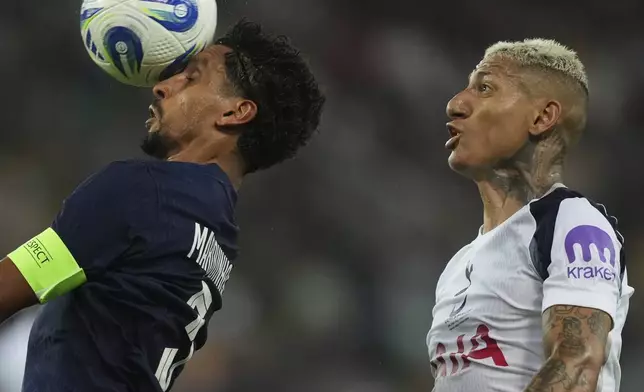PSG's Marquinhos, left, and Tottenham's Richarlison challenge for the ball during the UEFA Super Cup soccer match between Paris Saint-Germain and Tottenham Hotspur in Udine, Italy, Wednesday, Aug. 13, 2025. (AP Photo/Antonio Calanni)