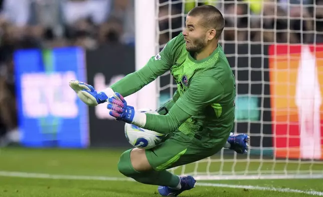 PSG's goalkeeper Lucas Chevalier saves during a penalty shootout during the UEFA Super Cup soccer match between Paris Saint-Germain and Tottenham Hotspur in Udine, Italy, Wednesday, Aug. 13, 2025. (AP Photo/Darko Bandic)