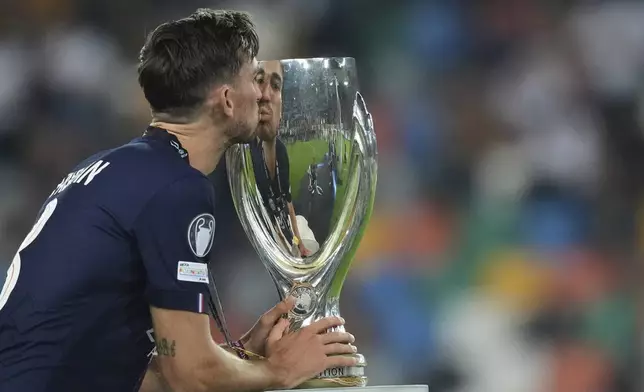 PSG's Fabian Ruiz kisses the trophy after the UEFA Super Cup soccer match between Paris Saint-Germain and Tottenham Hotspur in Udine, Italy, Wednesday, Aug. 13, 2025. (AP Photo/Antonio Calanni)