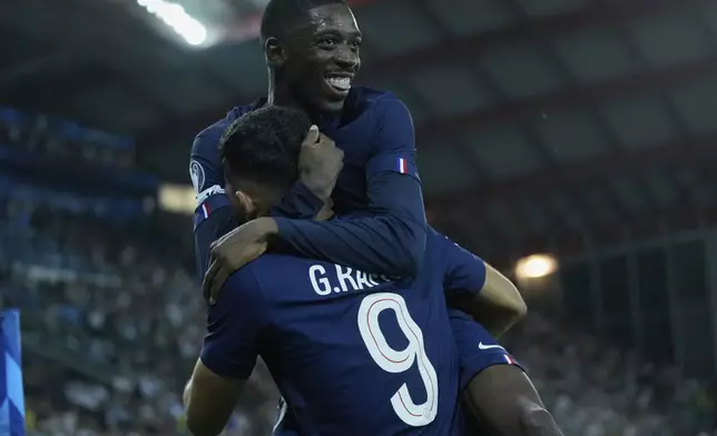 PSG's Goncalo Ramos and Ousmane Dembele celebrate after a goal during the UEFA Super Cup soccer match between Paris Saint-Germain and Tottenham Hotspur in Udine, Italy, Wednesday, Aug. 13, 2025. (AP Photo/Darko Bandic)