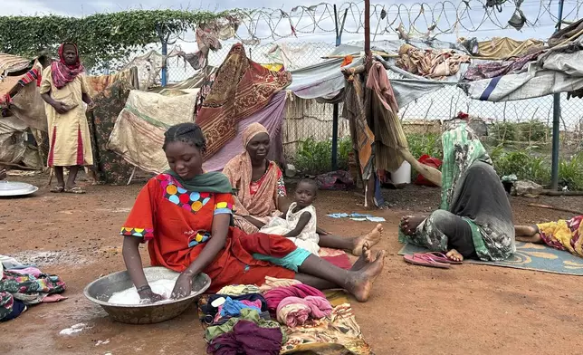 Women do laundry at the Renk transit center, which hosts more than 12,000 people fleeing the war in Sudan, in Renk, South Sudan, Saturday, Aug 9, 2025. (AP Photo/Adlai Coleman)