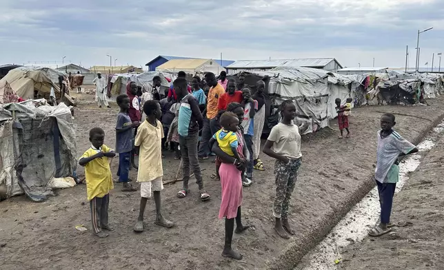Children gather at the Renk transit center, which hosts people fleeing the war in Sudan, in Renk, South Sudan, Saturday, Aug 9, 2025. (AP Photo/Joseph Falzetta)