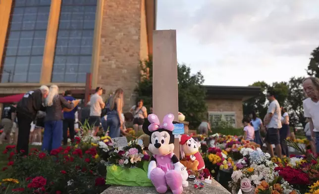 Items are left at a memorial at Annunciation Catholic Church after Wednesday's school shooting, Thursday, Aug. 28, 2025, in Minneapolis. (AP Photo/Abbie Parr)