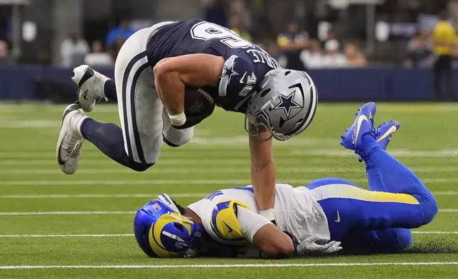 Los Angeles Rams safety Nate Valcarcel (43) tackles Dallas Cowboys tight end Tyler Neville (46) during the first half of an NFL preseason football game, Saturday, Aug. 9, 2025, in Inglewood, Calif. (AP Photo/Mark J. Terrill)
