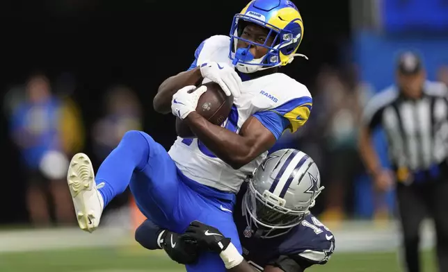 Los Angeles Rams wide receiver Xavier Smith (19) makes a catch over Dallas Cowboys safety Markquese Bell (14) during the first half of an NFL preseason football game, Saturday, Aug. 9, 2025, in Inglewood, Calif. (AP Photo/Mark J. Terrill)
