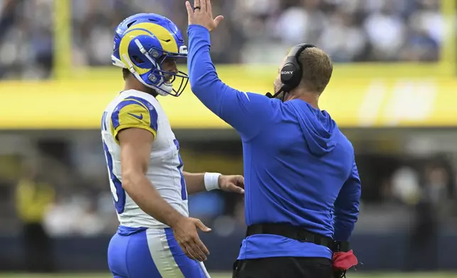 Los Angeles Rams quarterback Stetson Bennett IV (13) and head coach Sean McVay celebrate after a touchdown against the Dallas Cowboys during the first half of an NFL preseason football game, Saturday, Aug. 9, 2025, in Inglewood, Calif. (AP Photo/Wally Skalij)