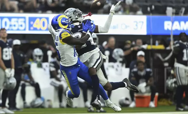 Dallas Cowboys safety Israel Mukuamu (24) intercepts a pass intended for Los Angeles Rams wide receiver Konata Mumpfield (15) during the second half of an NFL preseason football game, Saturday, Aug. 9, 2025, in Inglewood, Calif. (AP Photo/Wally Skalij)