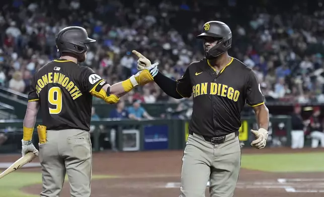 San Diego Padres' Xander Bogaerts, right, celebrates his home run against the Arizona Diamondbacks with Padres' Jake Cronenworth (9) during the second inning of a baseball game Tuesday, Aug. 5, 2025, in Phoenix. (AP Photo/Ross D. Franklin)