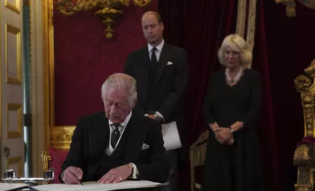 FILE - Britain's King Charles III signs an oath to uphold the security of the Church in Scotland during the Accession Council at St James's Palace, London, Saturday, Sept. 10, 2022, where he was formally proclaimed monarch. (Victoria Jones/Pool Photo via AP, File)