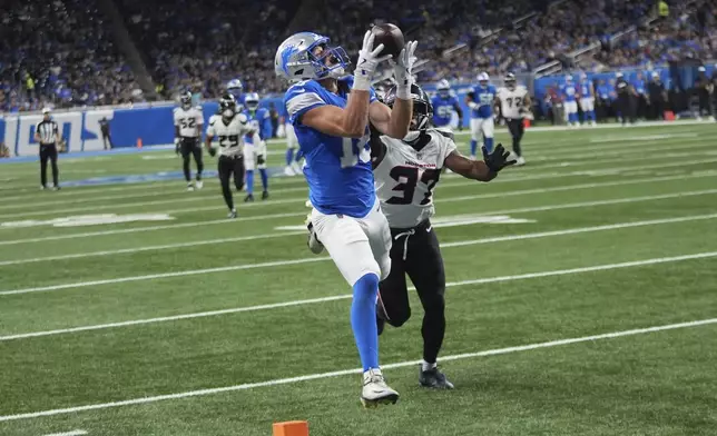 Detroit Lions wide receiver Isaac TeSlaa (18) catches a pass for a touchdown as Houston Texans cornerback D'Angelo Ross (37) defends during the first half of an NFL football game Saturday, Aug. 23, 2025, in Detroit. (AP Photo/Paul Sancya)