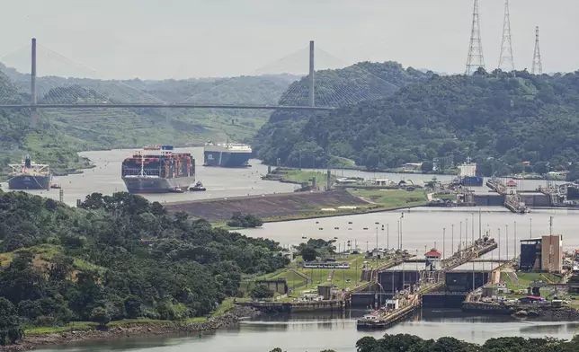 A cargo ship navigates through the Panama Canal, seen from the Cerro Ancon in Panama City, Tuesday, July 29, 2025. (AP Photo/Matias Delacroix)
