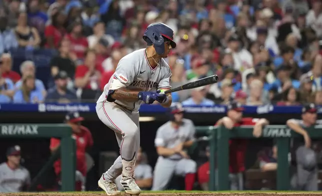 Washington Nationals' Daylen Lile watches after hitting a run-scoring single against Philadelphia Phillies pitcher Jhoan Duran during the ninth inning of a baseball game Friday, Aug. 22, 2025, in Philadelphia. (AP Photo/Matt Slocum)