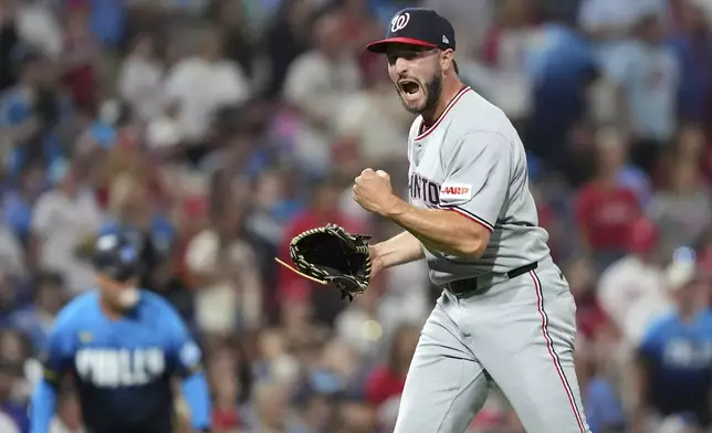 Washington Nationals pitcher PJ Poulin reacts after the Nationals won a baseball game against the Philadelphia Phillies Friday, Aug. 22, 2025, in Philadelphia. (AP Photo/Matt Slocum)