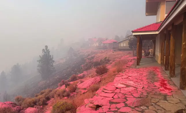 Deschutes County Sheriff's Office shows shows homes covered in fire retardant dropped from firefighting aircraft for battling the Flat Fire in central Oregon, Sunday, Aug. 24, 2025. (Deschutes County Sheriff's Office via AP)