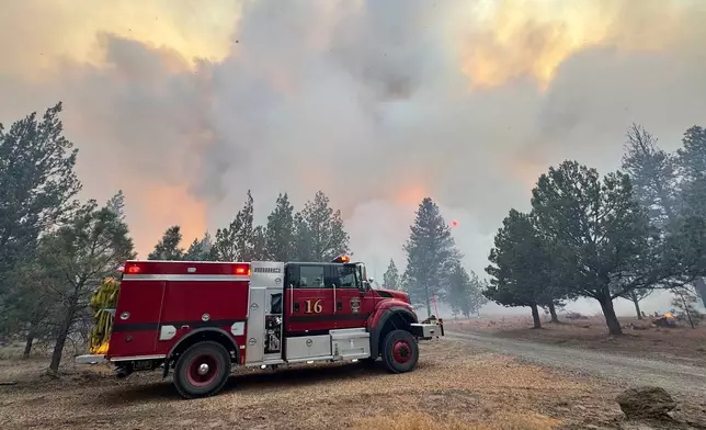 This photo provided by Deschutes County Sheriff's Office shows crews battling the Flat Fire in central Oregon, on Sunday, Aug. 24, 2025. (Deschutes County Sheriff's Office via AP)