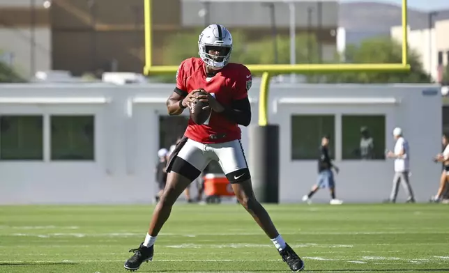 Las Vegas Raiders quarterback Geno Smith (7) runs through a drill during the team's NFL football training camp, Sunday, July 27, 2025, in Henderson, Nev. (AP Photo/Candice Ward)