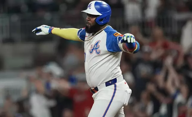 Atlanta Braves designated hitter Marcell Ozuna (20) celebrates his three-run homer against the Miami Marlins in the fifth inning in the second baseball game of a doubleheader, Saturday, Aug. 9, 2025, in Atlanta. (AP Photo/Mike Stewart)