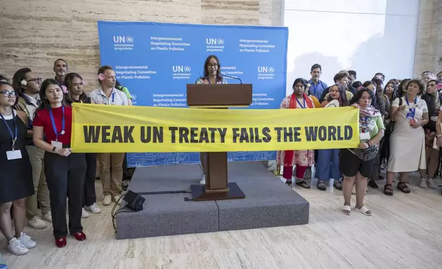 Activists stage a protest during a plenary session of Second Part of the Fifth Session of the Intergovernmental Negotiating Committee on Plastic Pollution at the European headquarters of the United Nations in Geneva, Switzerland, Thursday, Aug. 14, 2025. (Martial Trezzini/Keystone via AP)