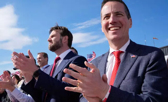 FILE - Sen. J.D. Vance, center, and Senate candidate Bernie Moreno, right, applaud as Republican presidential candidate and former President Donald Trump speaks at a campaign rally in Vandalia, Ohio, March 16, 2024. (AP Photo/Jeff Dean, File)