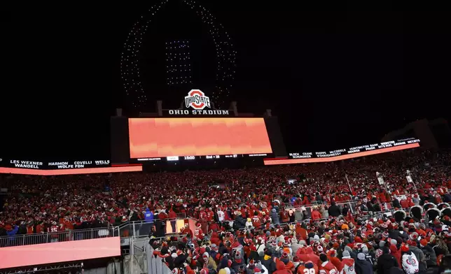 FILE - Fans watch a drone show displaying the CFP logo above Ohio Stadium during the second half in the first round of the College Football Playoff between Ohio State and Tennessee, Saturday, Dec. 21, 2024, in Columbus, Ohio. (AP Photo/Jay LaPrete, File)