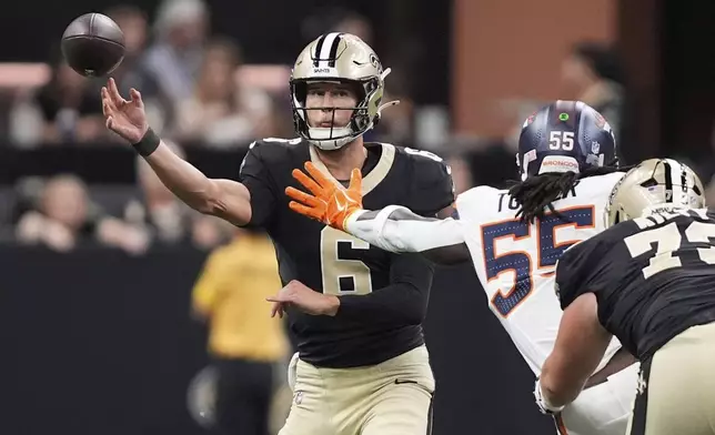 New Orleans Saints quarterback Tyler Shough, left, passes the ball under pressure from Denver Broncos linebacker Jordan Turner in the second half of an NFL preseason football game Saturday, Aug. 23, 2025, in New Orleans. (AP Photo/Gerald Herbert)