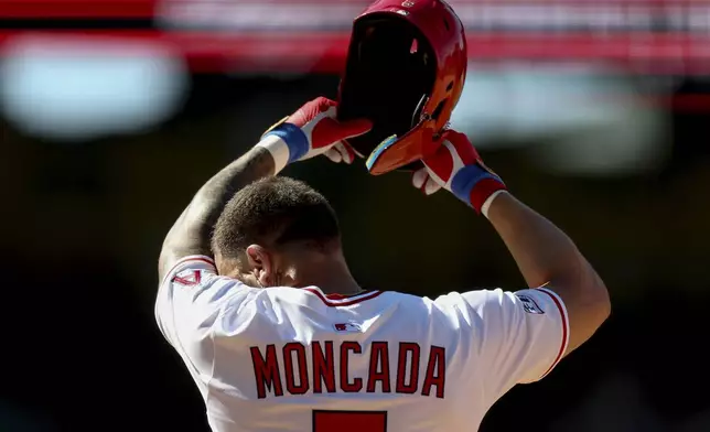 Los Angeles Angels' Yoan Moncada wipes away sweat during the ninth inning of a baseball game against the Chicago Cubs Sunday, Aug. 24, 2025, in Anaheim, Calif. (AP Photo/Eric Thayer)