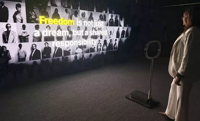 Miami Dade College President Madeline Pumariega explores a museum exhibit honoring Cuban exiles at the Freedom Tower in Miami on Friday, Aug. 8, 2025. (AP Photo/Joshua Goodman)